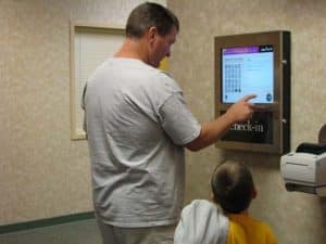 Wall Mounted Kiosk In use for Check In