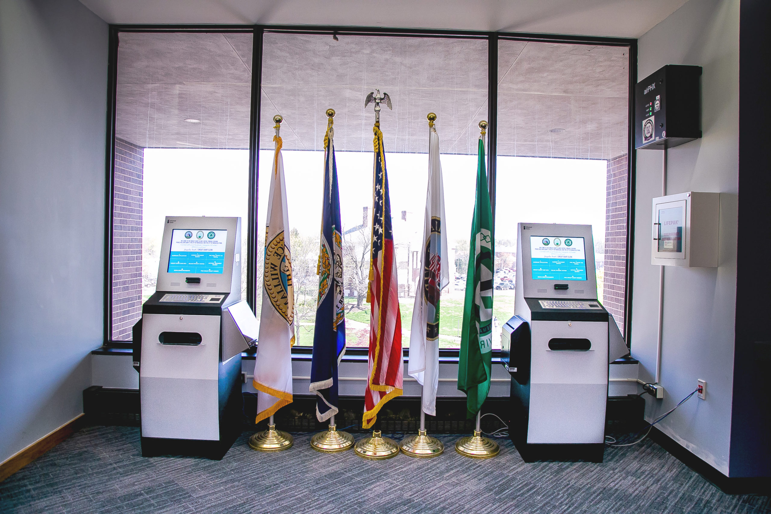 A pair of Self Service Document Kiosks in the lobby of a courthouse building with print and scan functionality.