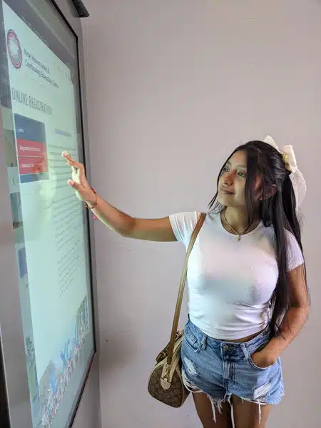 Student using large touchscreen education kiosk