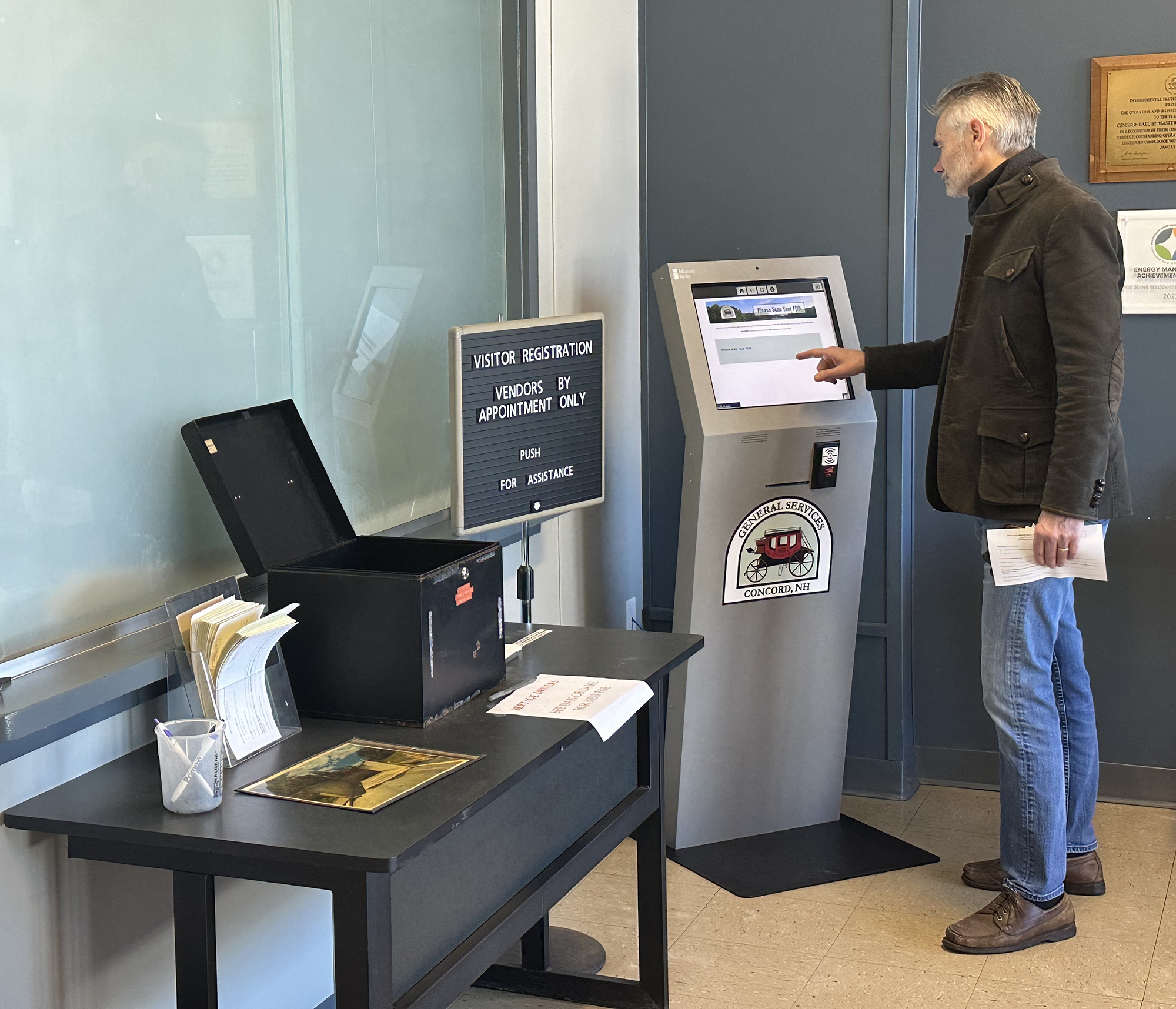 Man using government self service registration kiosk