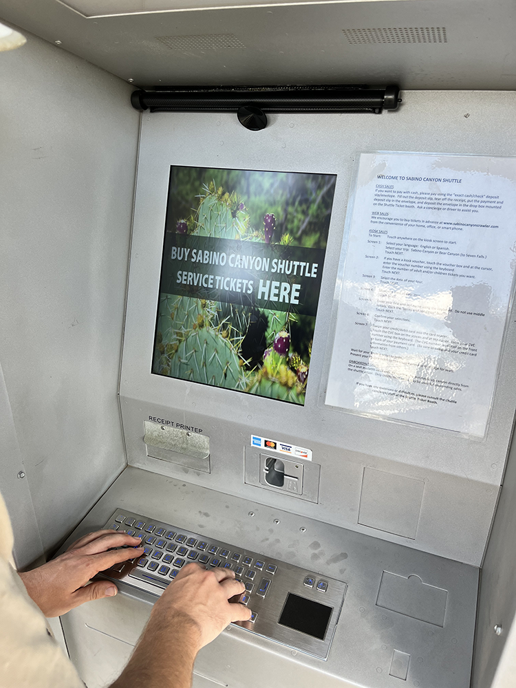 Thru-wall ticketing kiosk in use 1