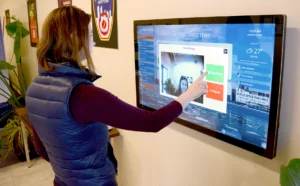 Visitor taking photo for nametag on wall-mounted touchscreen