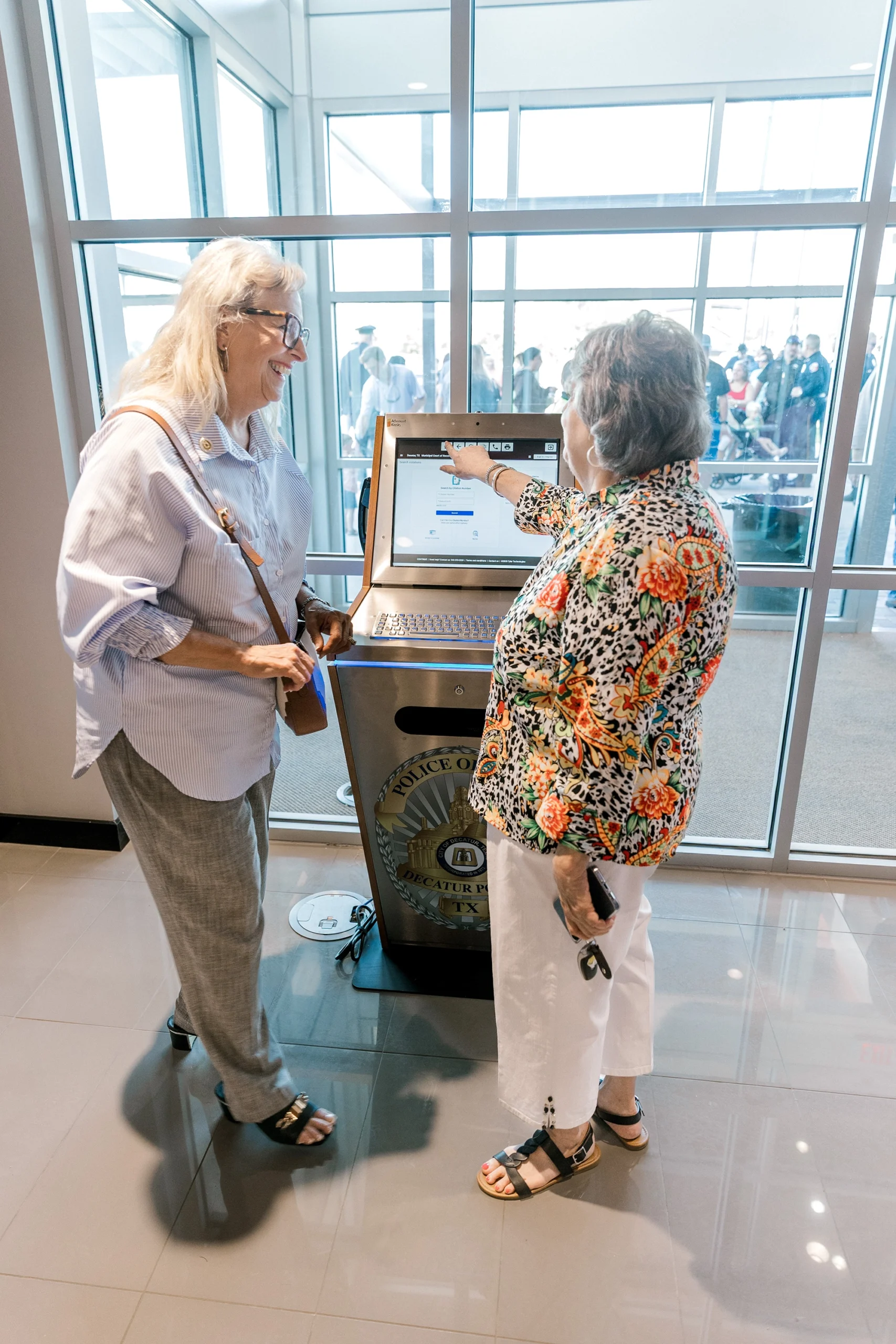 Women using police kiosk