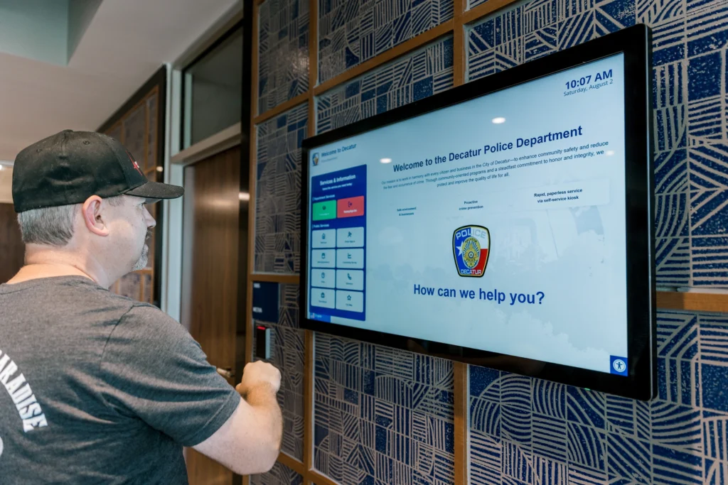 Man checking into police station on kiosk