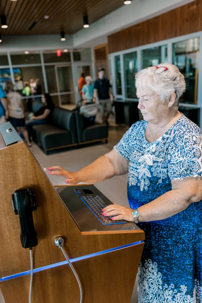 Woman using kiosk in police station