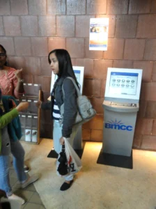 Borough of Manhattan Community College student with kiosk