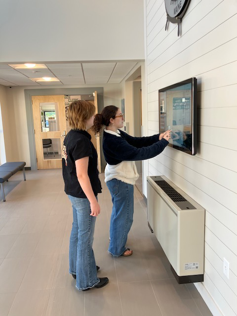 People using touchscreen kiosk