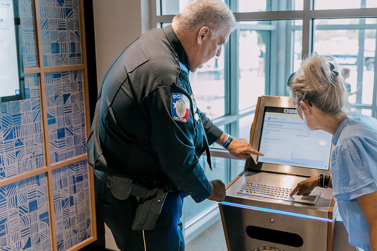Policeman demonstrating lobby kiosk